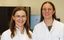 The two scientists, Katharina Rahmel-Stein and Dr Ines Tapken, are standing in front of a flow cytometer wearing white lab coats.